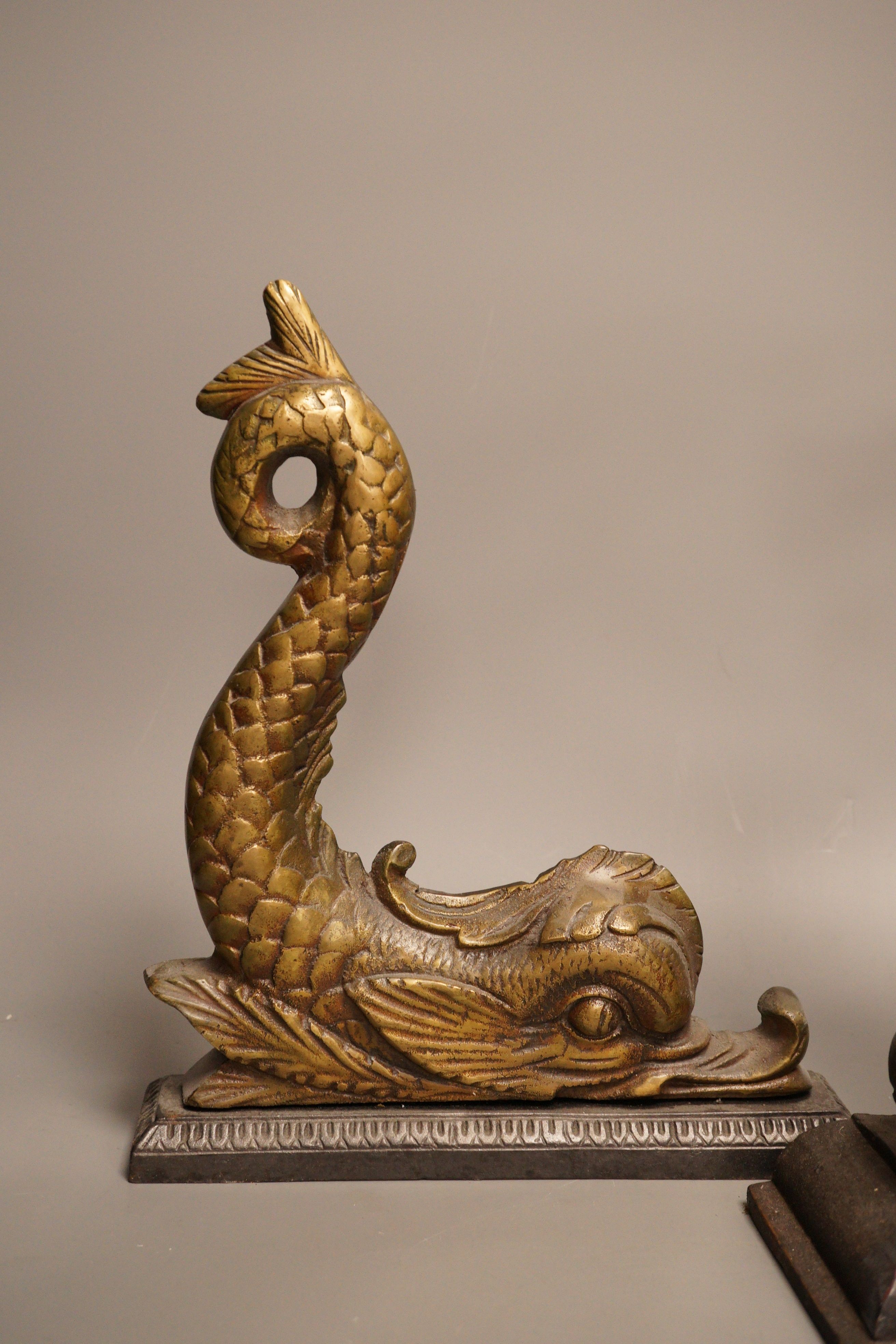 Two cast iron or brass ‘dolphin’ door stops, tallest 38cm